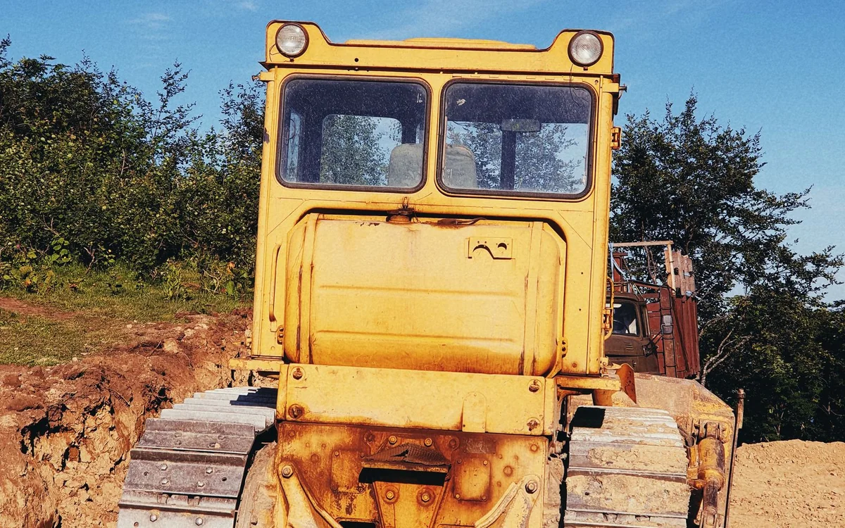 Yellow tracked bulldozer on an earthwork site
